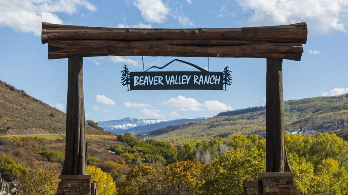 beaver valley ranch sign hanging between two wooden posts