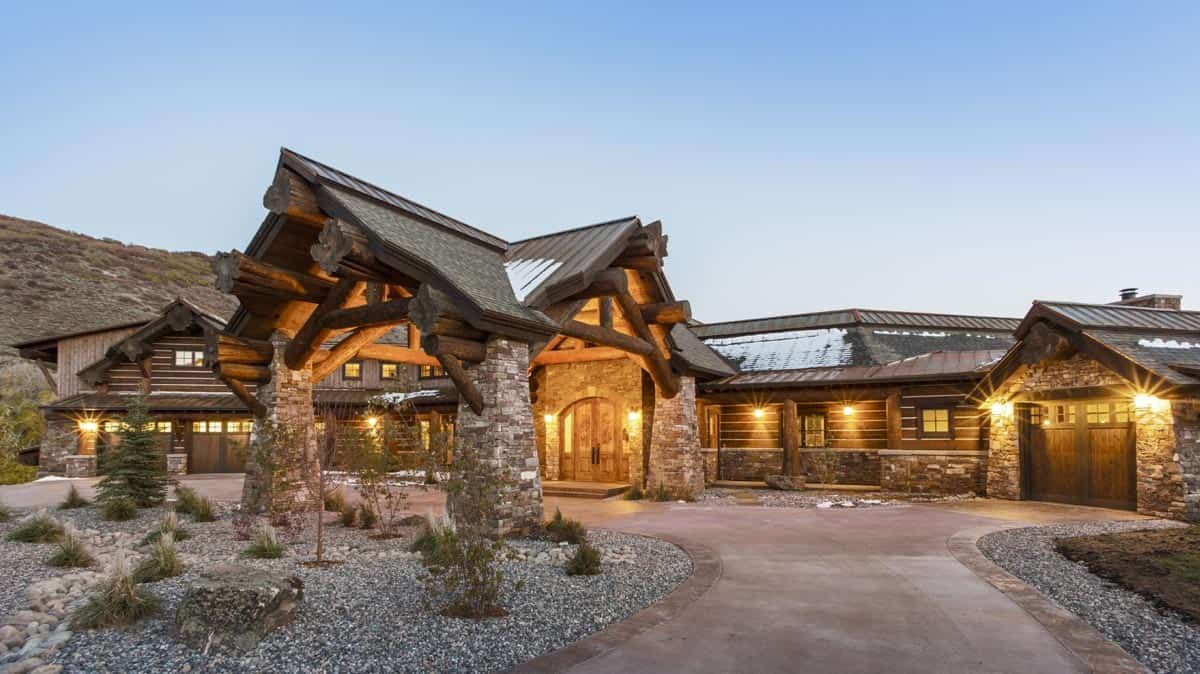 covered awning in front of log cabin with stone columns