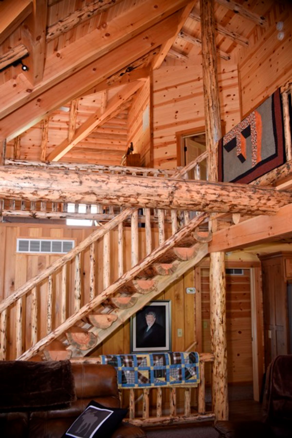log stairs up to loft with whole log railings