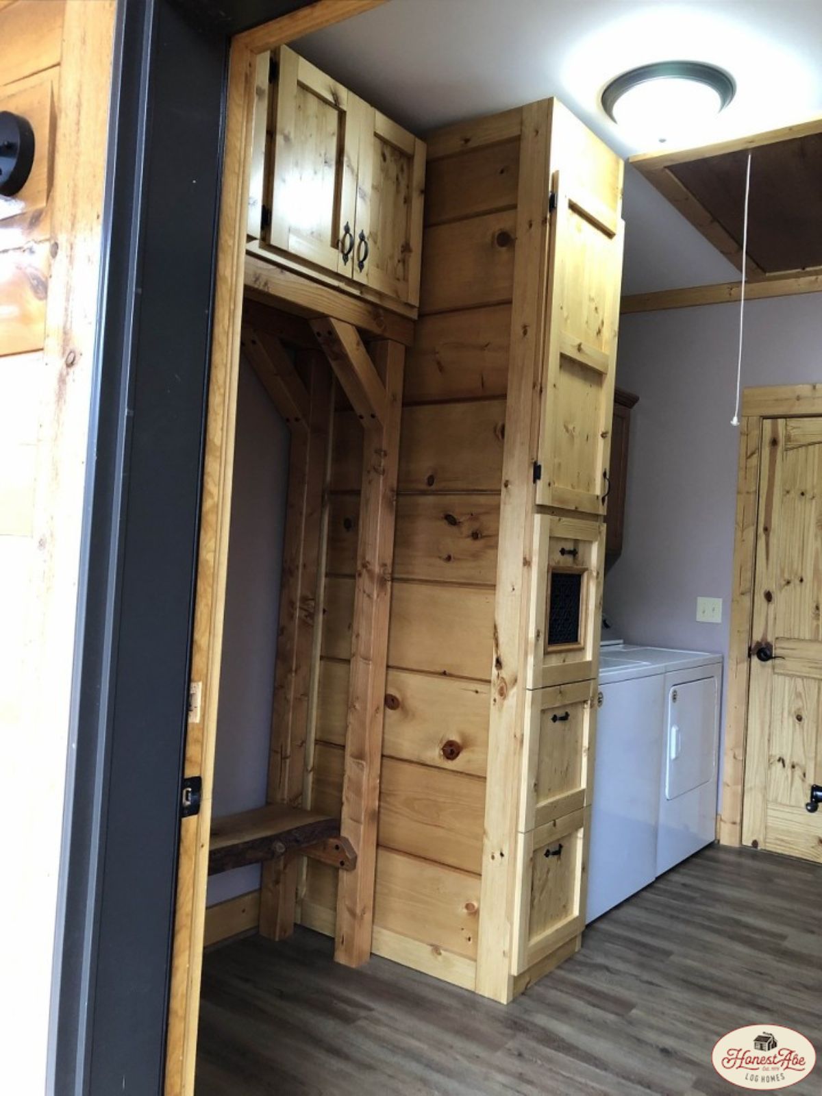 laundry room with white appliances and light wood cabinets