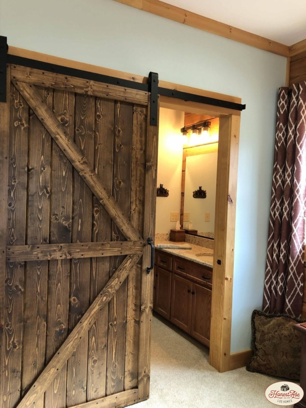 dark barn wood door on bathroom