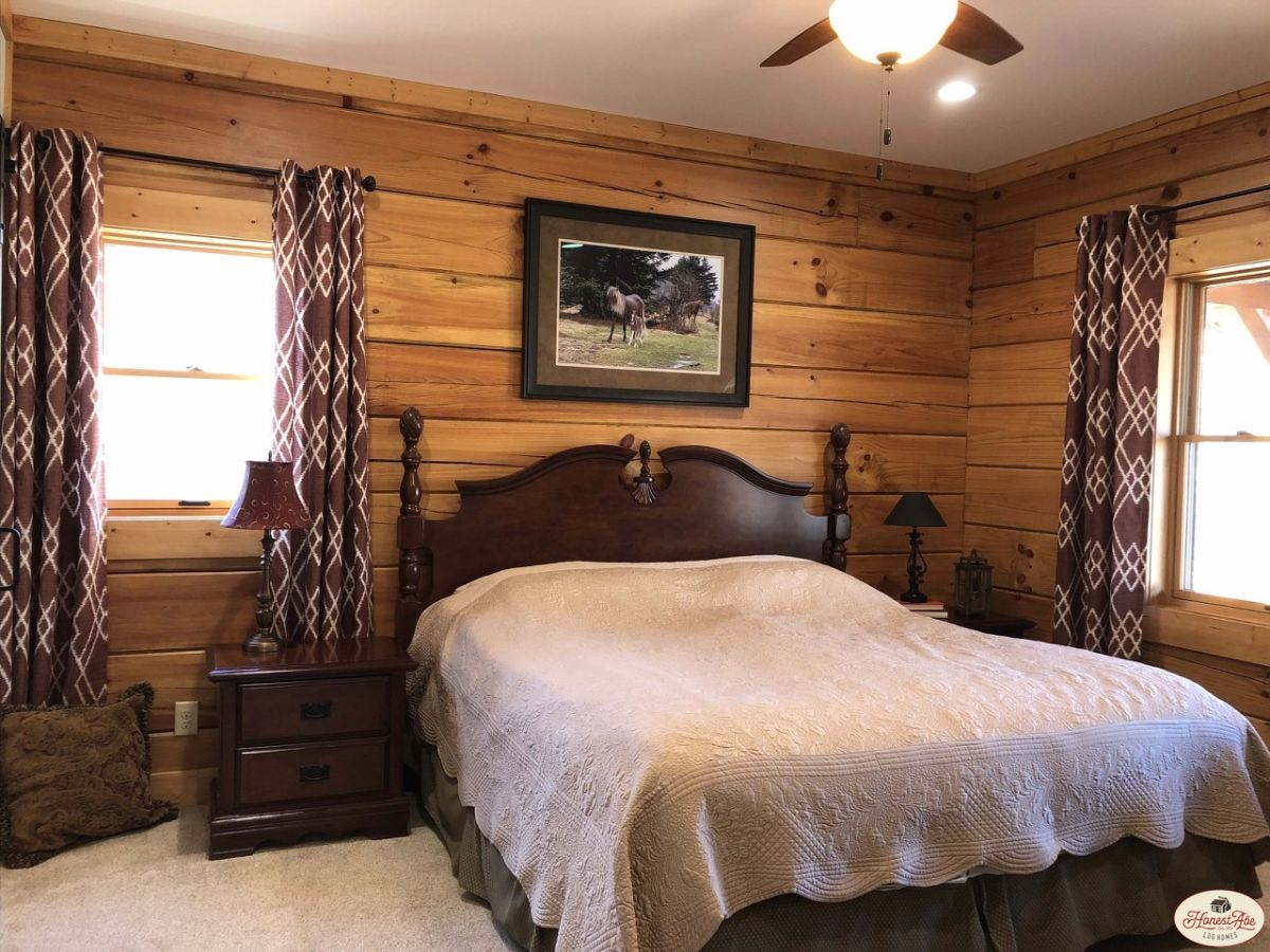 light bedding on dark wood bed frame with light wood walls