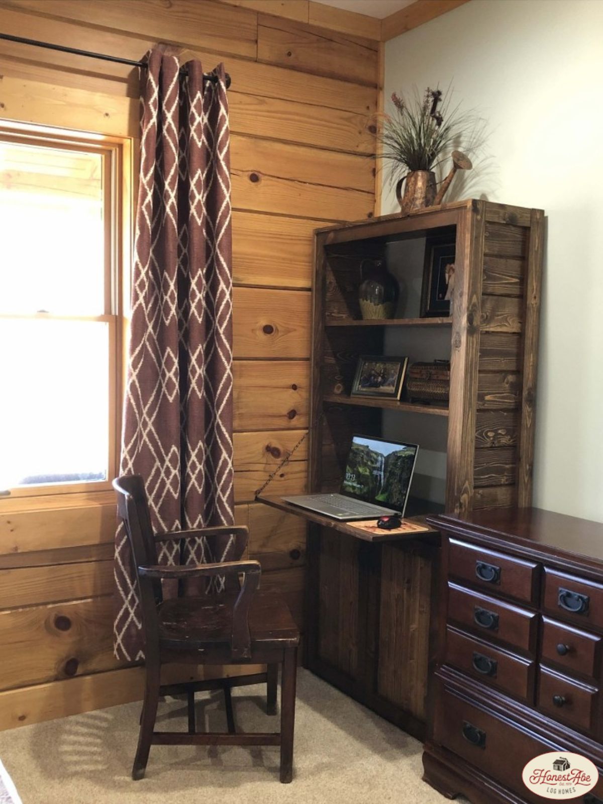 dark wood cabinet and roll top desk against wall with window