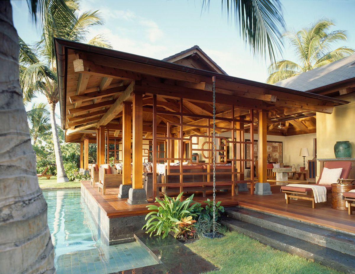 side of cabin with palm trees above and open air design