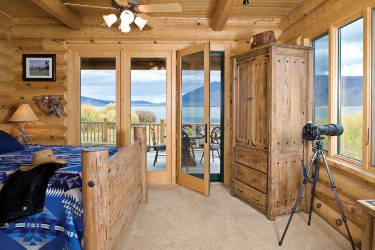 open door to balcony next to wardrobe in bedroom with blue bedding