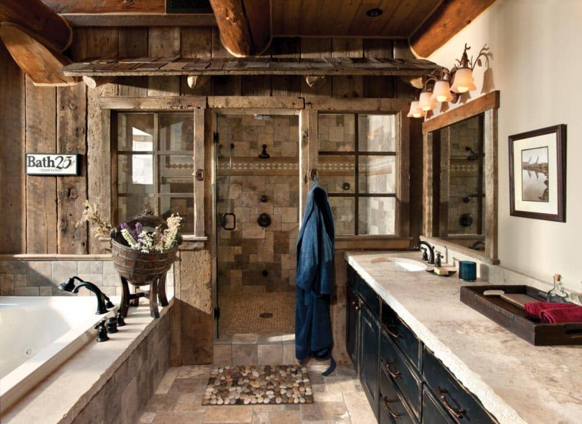 bathroom with soaking tub on left black cabinet vanity on right with shower in background