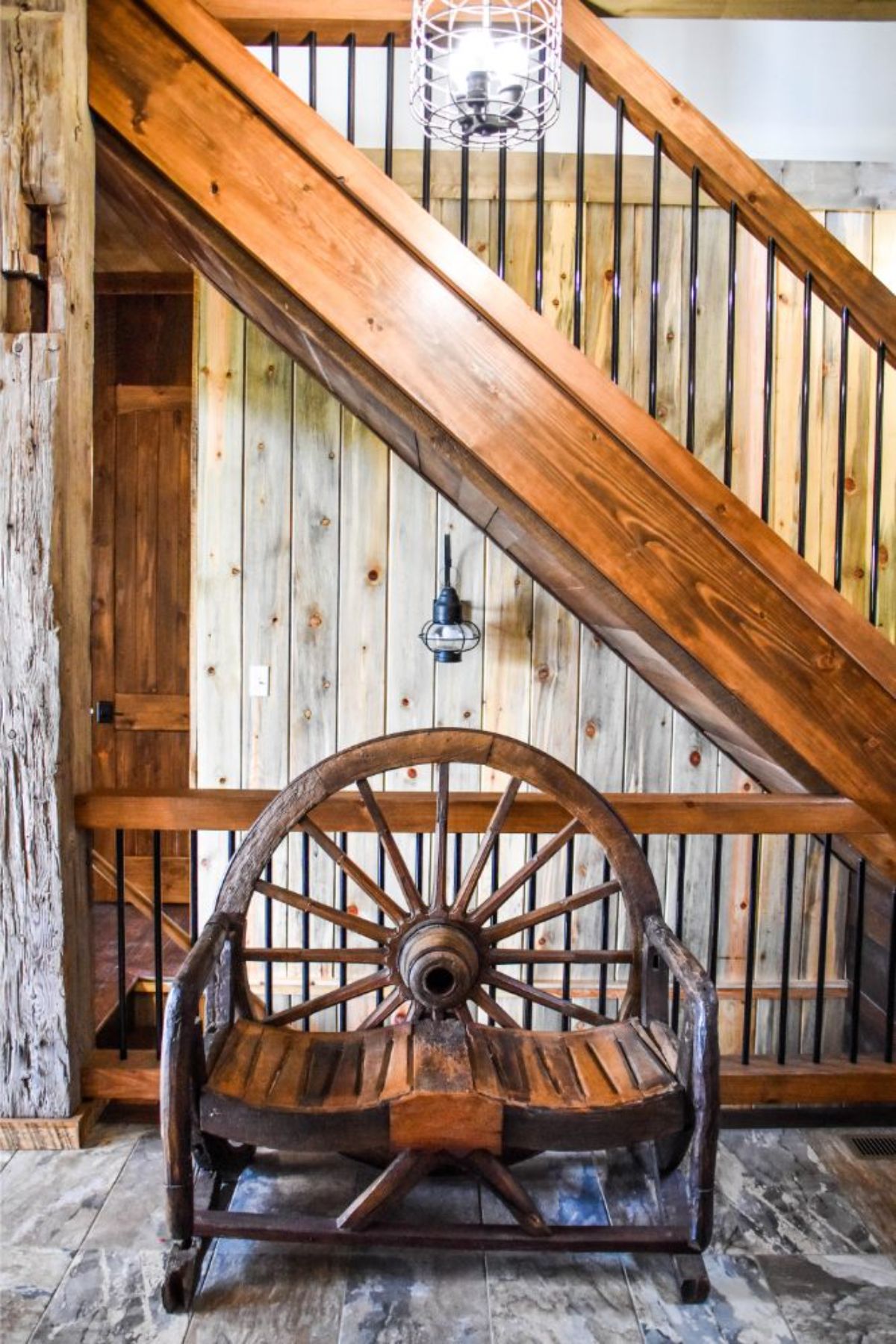wagon wheel bench by railing to stairs