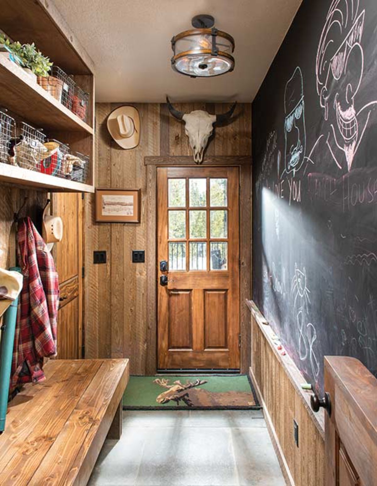 chalkboard wall on right with door at end and shelves on left