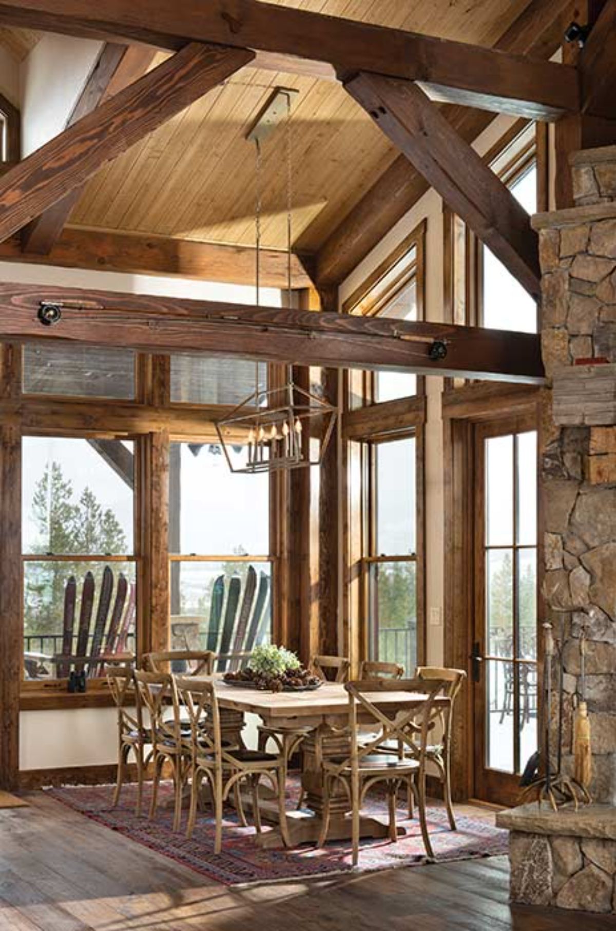 dining room with windows on all sides and view of Adirondack chairs outside window