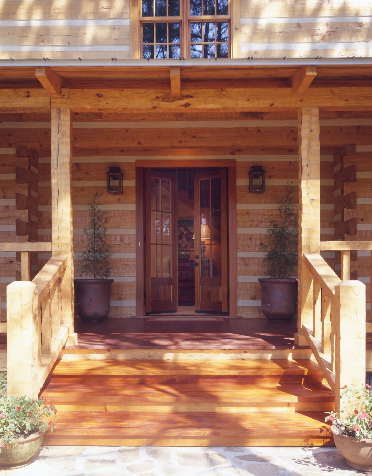 open front door on porch of log cabin