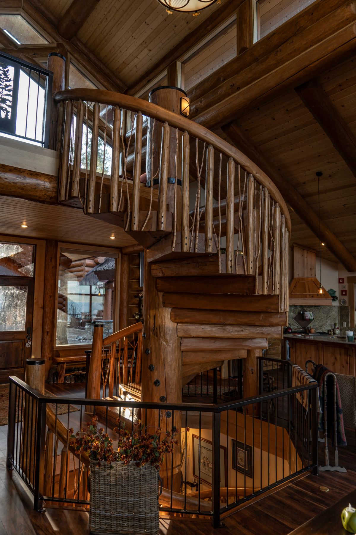 spiral staircase leading to second floor of log cabin