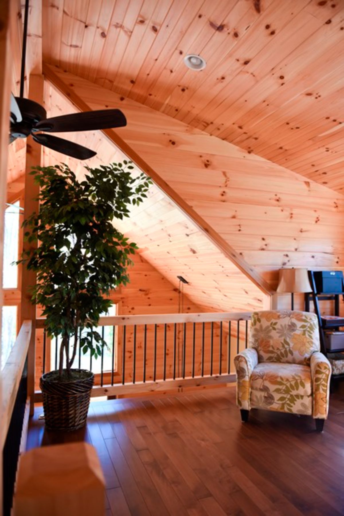 wood railing on edge of loft in cabin