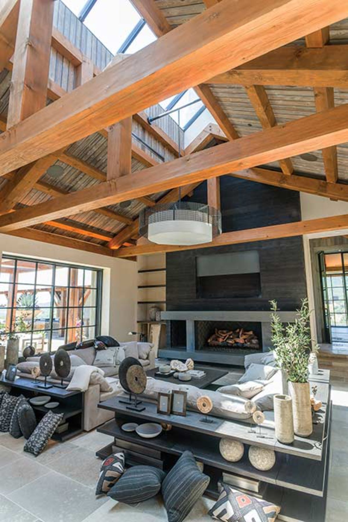 gray slate fireplace against back wall of living room with open beams above