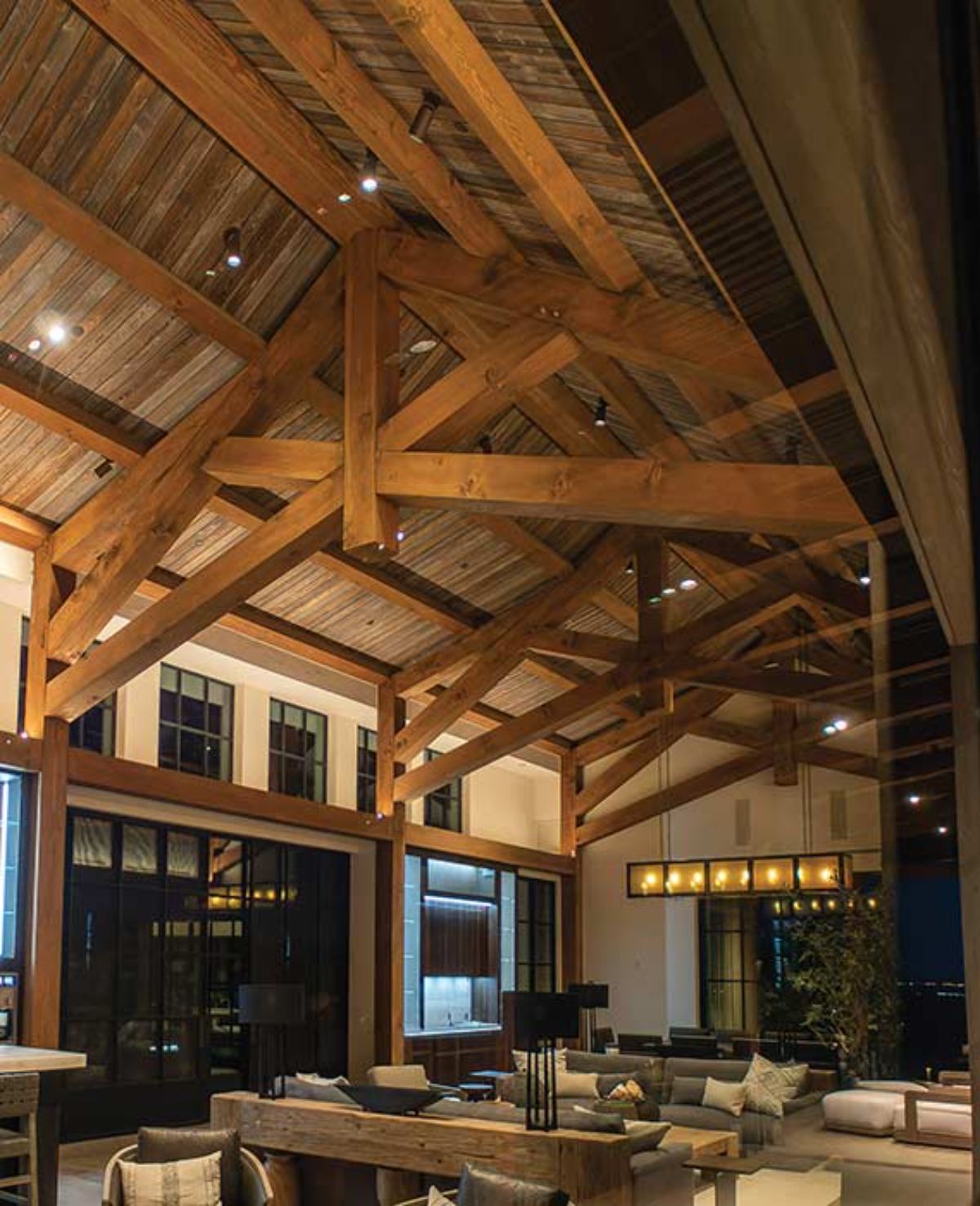 view across living space over dining table with exposed beams in ceiling