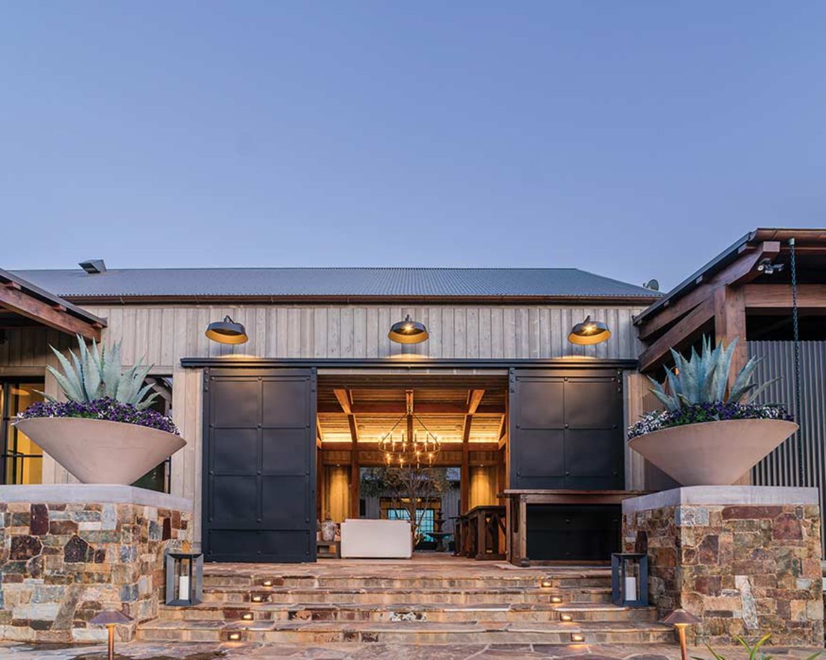 covered courtyard entrance with large black garage doors