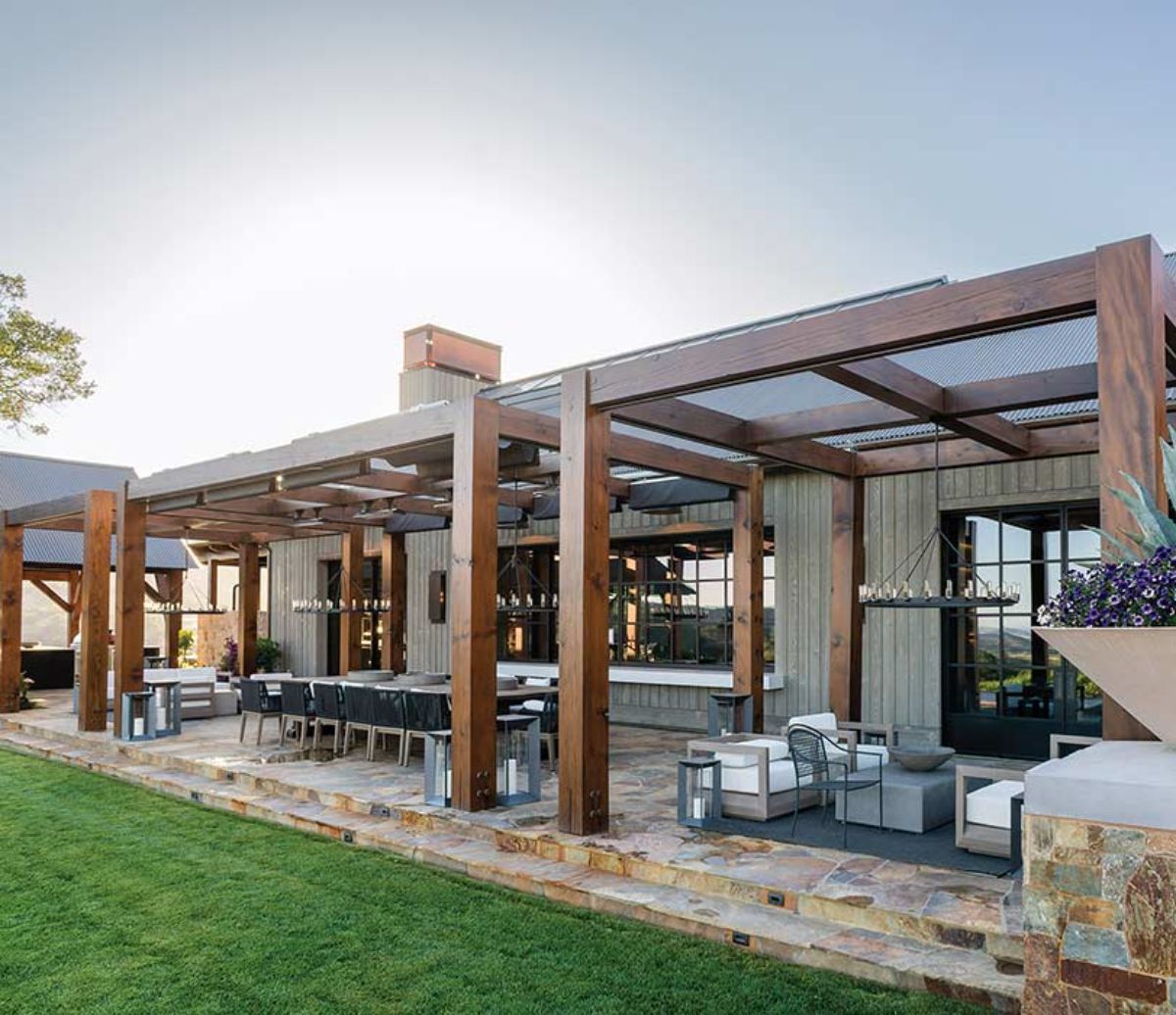 pergola and covered awning over back patio of cabin home