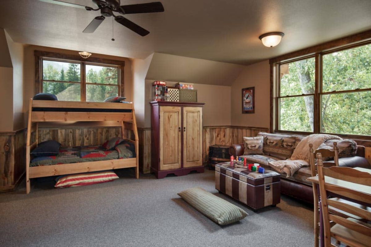 play room in loft of cabin with sofa under window