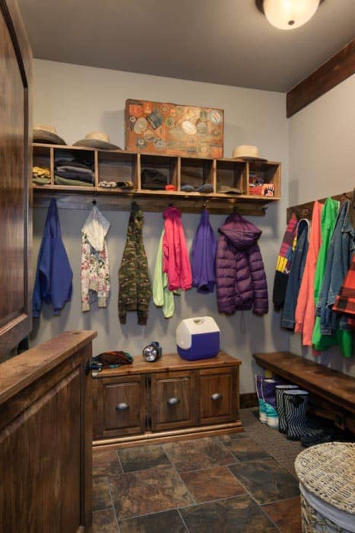 coat room with dark wood cabinets and cubbies