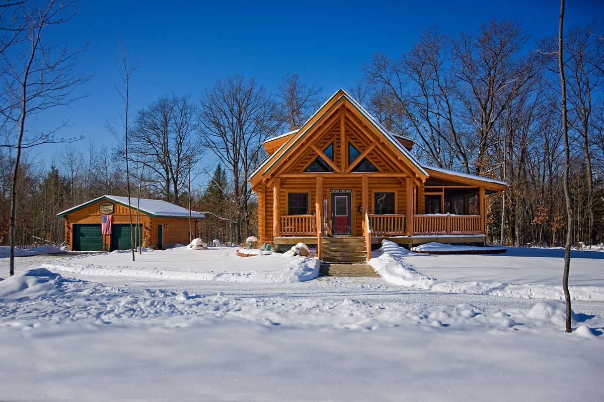 light wood on log cabin porch with railing and side porch