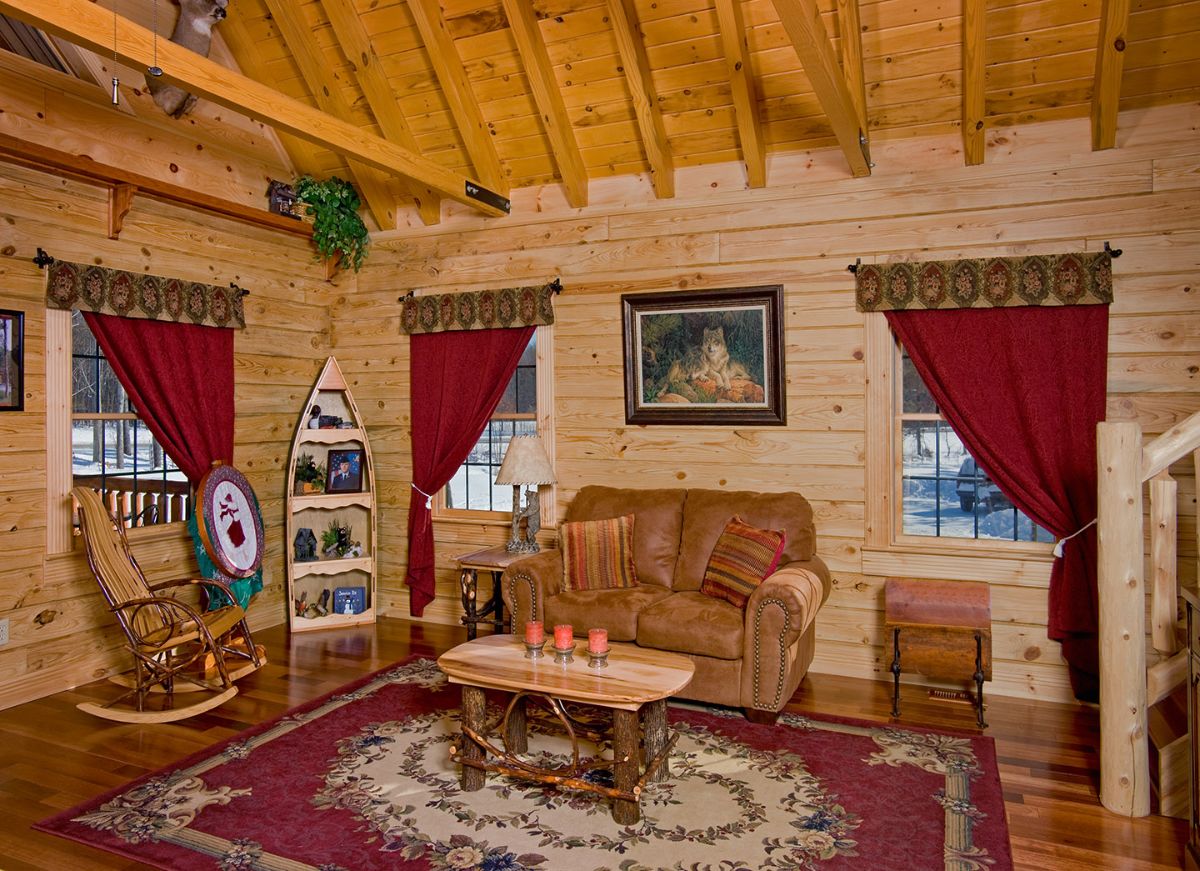 brown sofa against wall with red curtains on windows