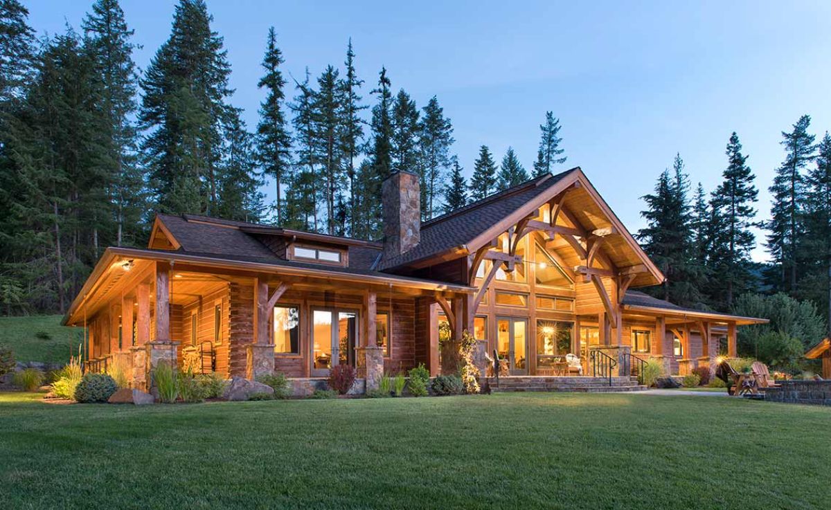 sprawling log cabin with trees in background