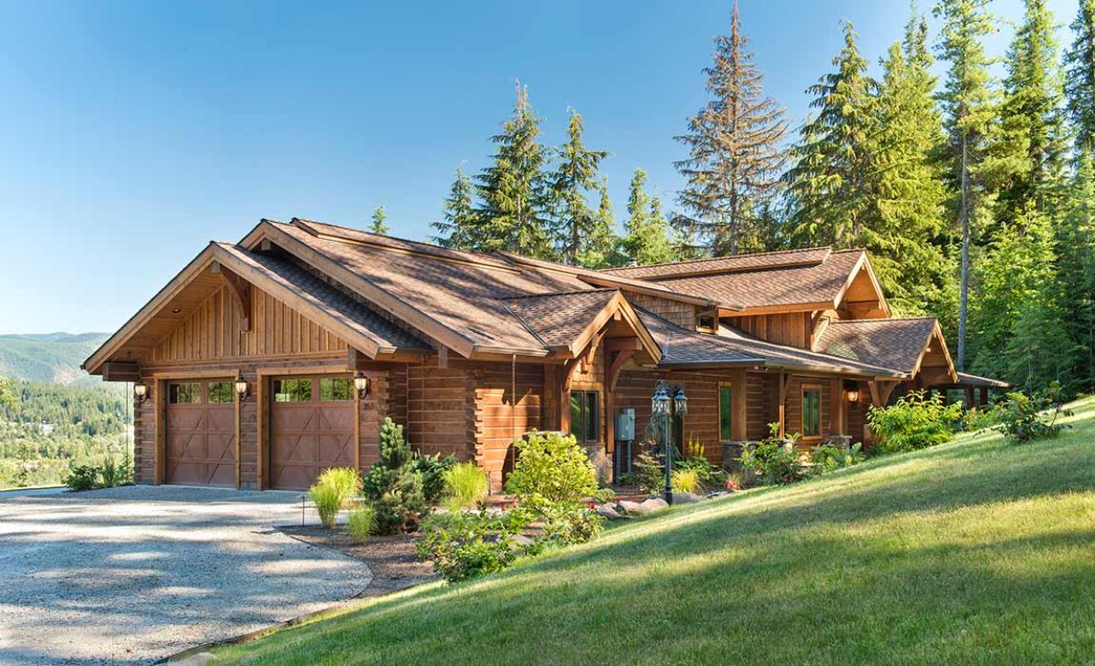 two car garage on end of log cabin on hill