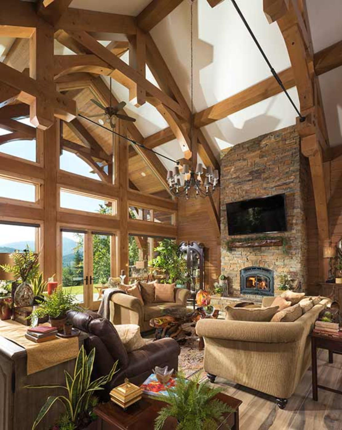 light brown sofas and chairs in front of fireplace on back wall with wall of windows on left