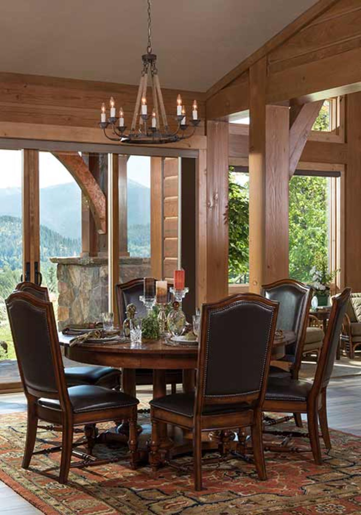 dark wood dining table with high back chairs and large windows in back ground