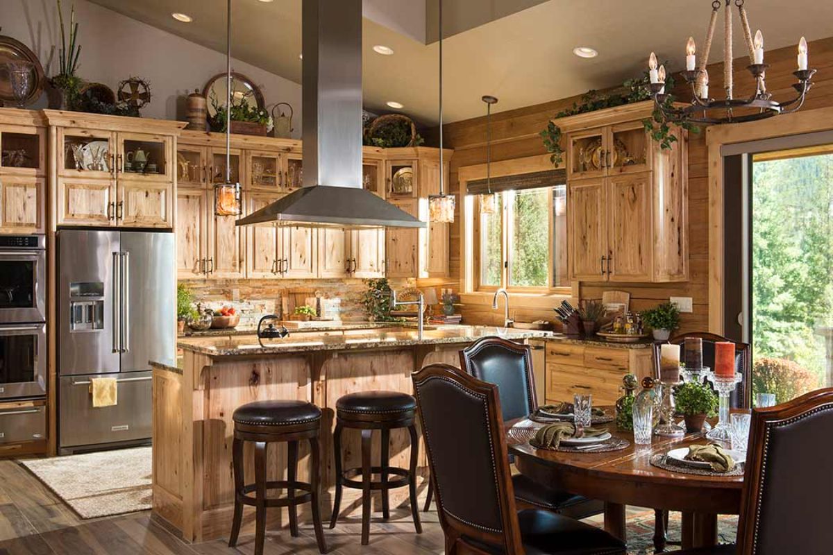 light wood cabinets and island base and dark wood stools on island