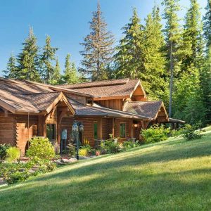 two car garage on end of log cabin on hill