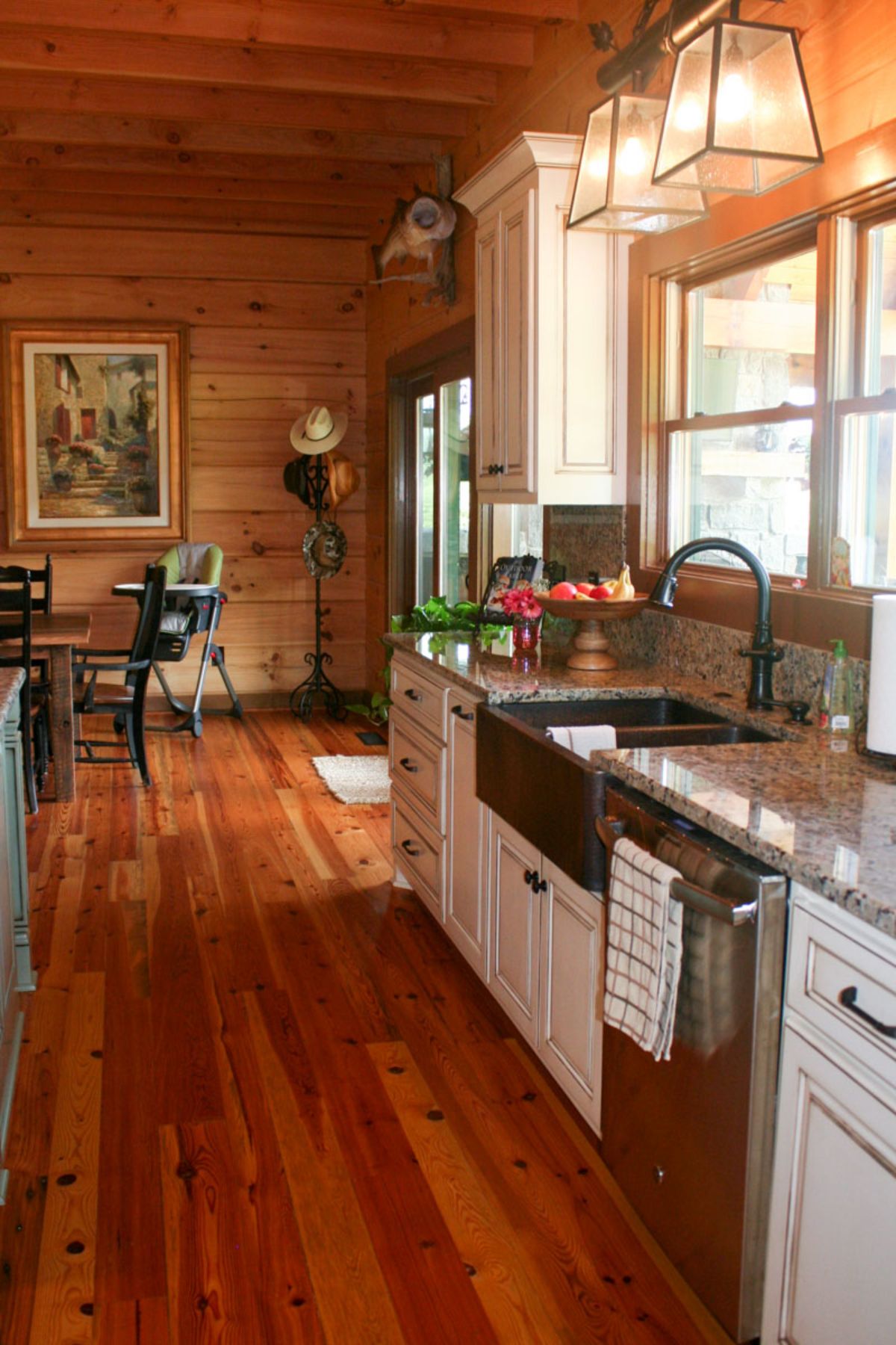 white cabinets around stainless steel dishwasher and sink