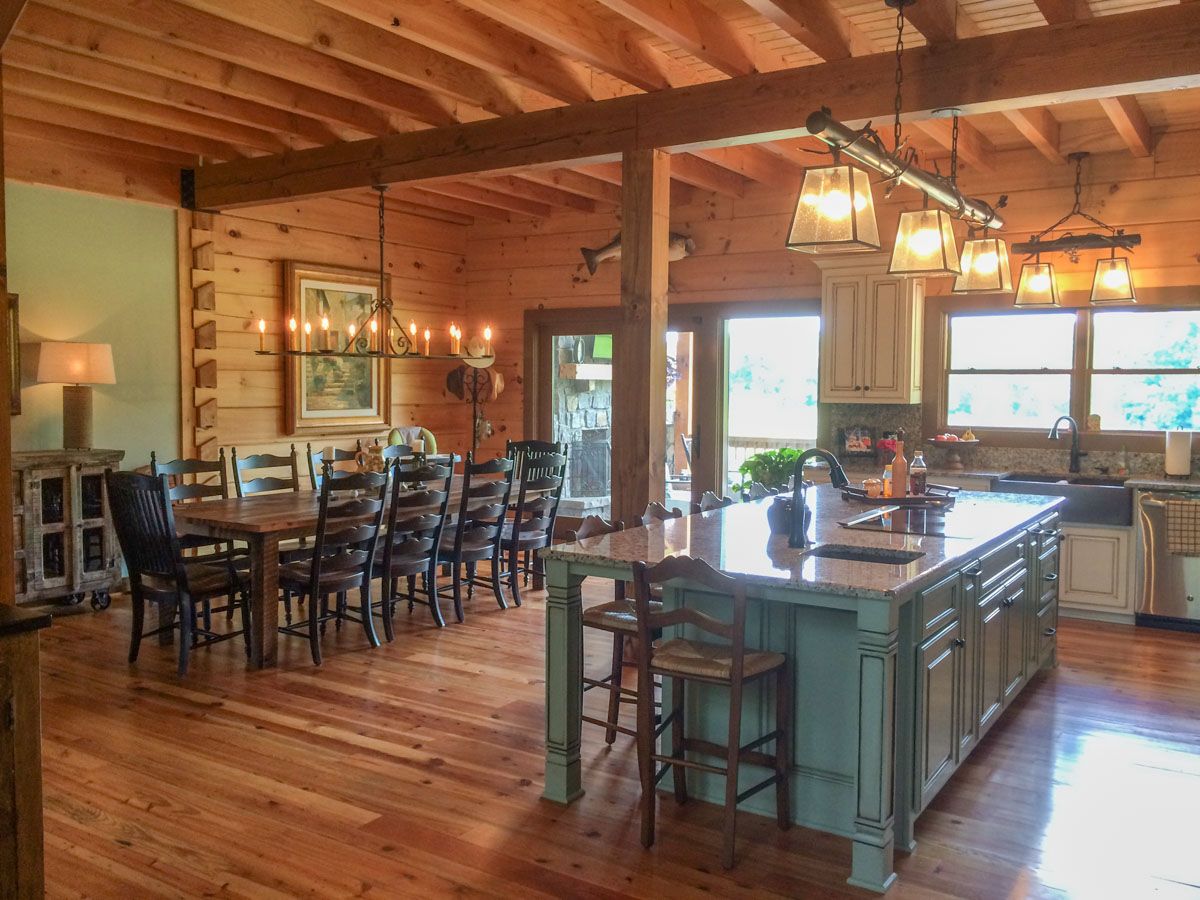 view across island of kitchen with stools on the end and dining table on the left