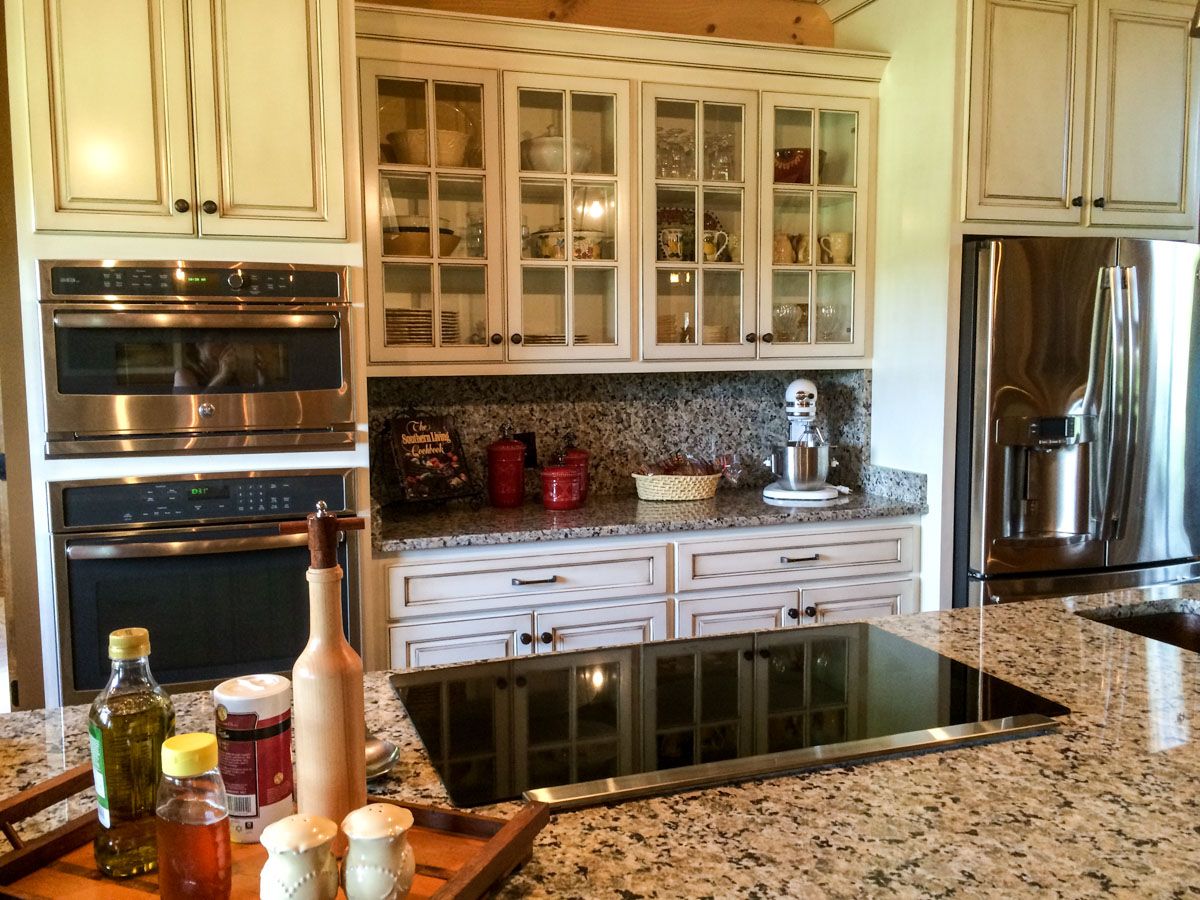 kitchen with white cabinets with glass windows and electric flat top stove