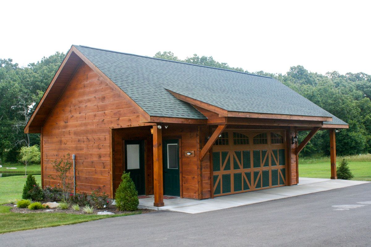 log garage with green and brown garage doors