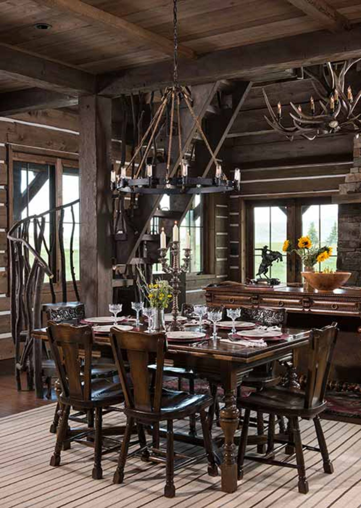dark wood chairs around dining table under rustic chandelier