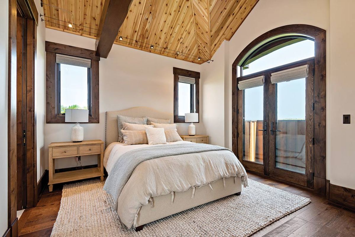 white bed and linens in bedroom with arched doorway