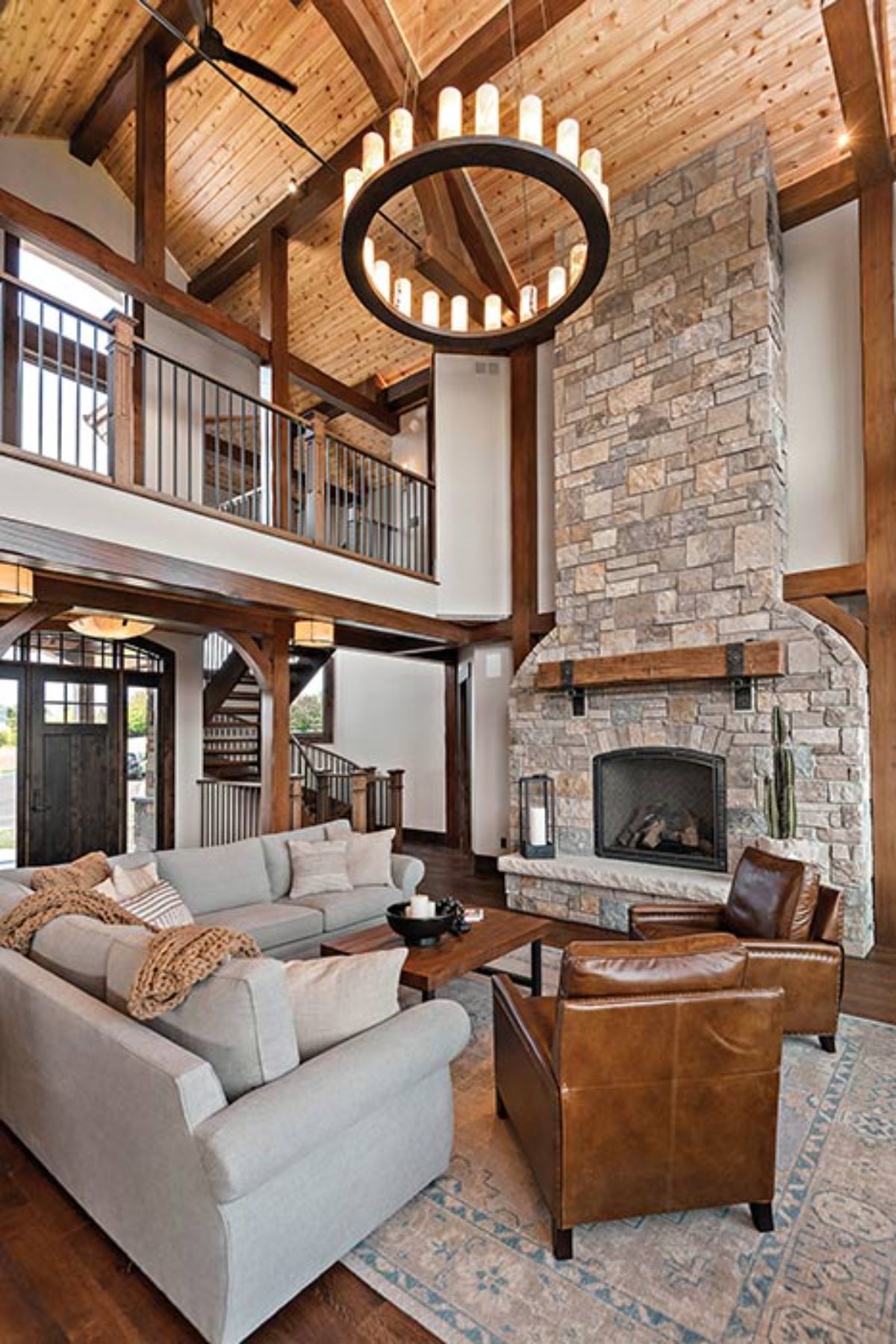 living room with light colored couch in foreground and light cream brick fireplace in background