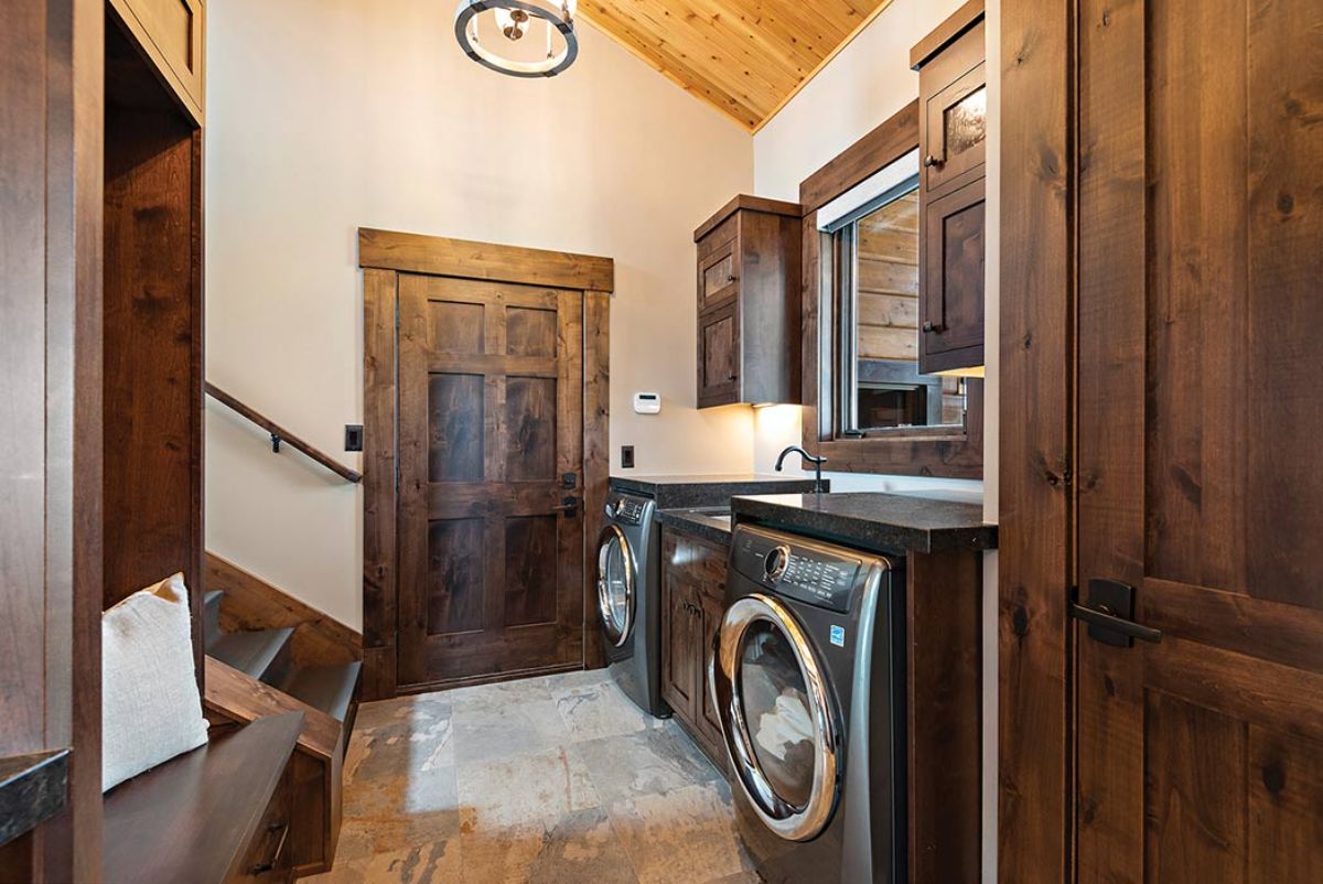 laundry room with dark wood cabinets