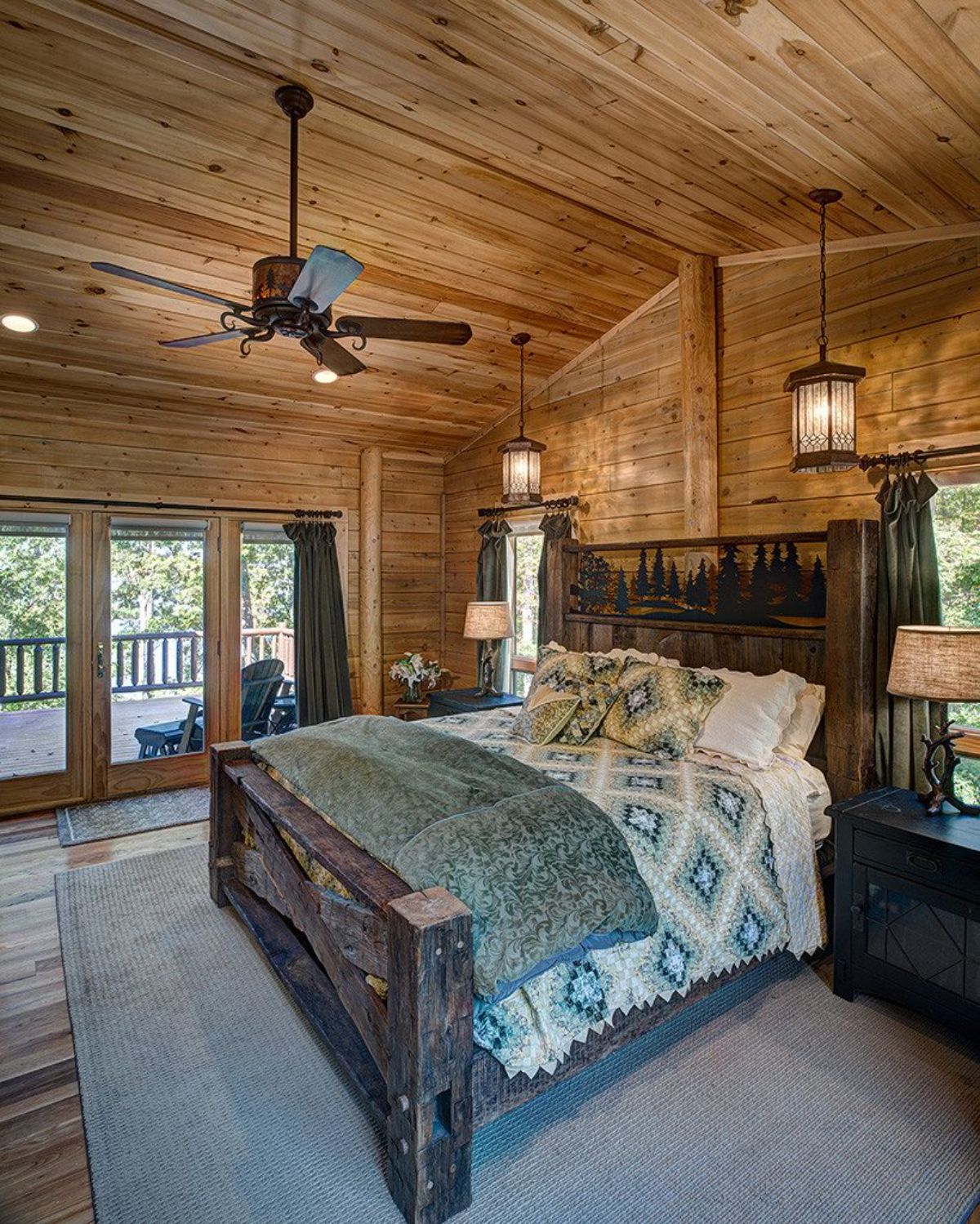 dark wood bed frame with green linens and glass door to patio on left