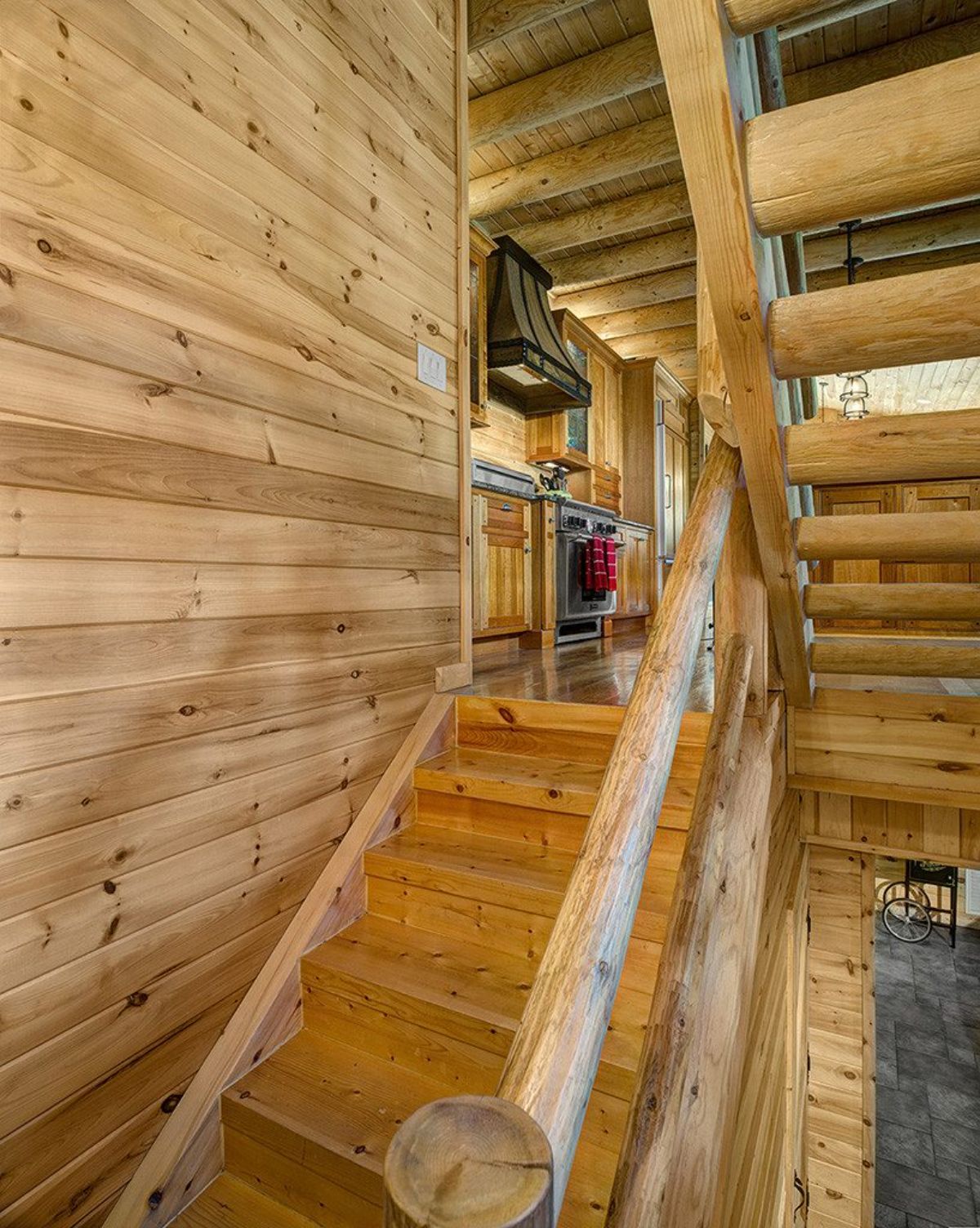 light pine wood stairs leading to basement and top floor of home