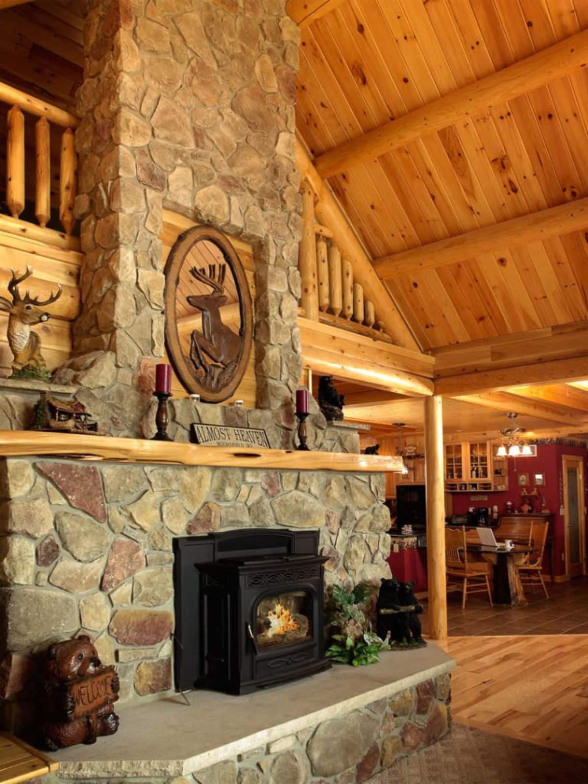 stone fireplace against left wall of living room in cabin