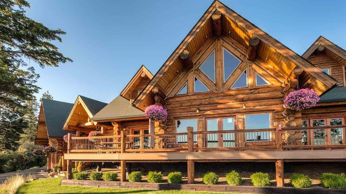 open deck on back of cabin with wall of windows