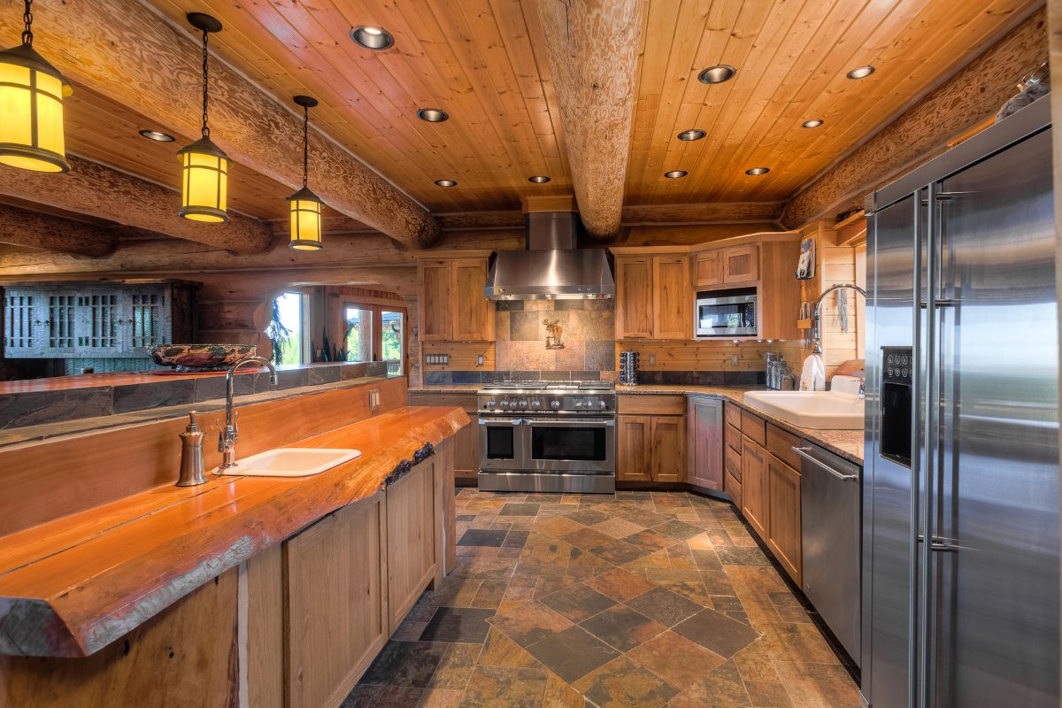 light wood kitchen cabinets with stainless steel stove at end of room