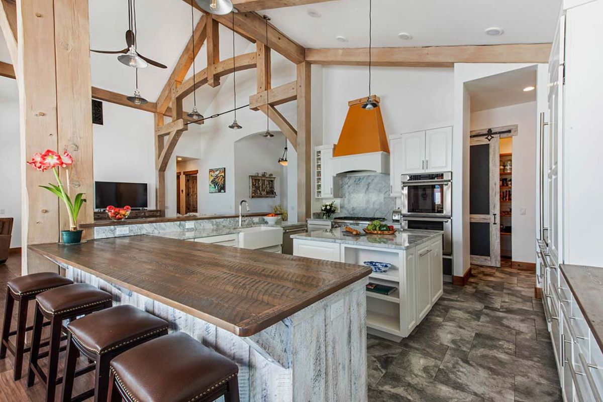 butcher block countertops on kitchen island with brown leather topped stools