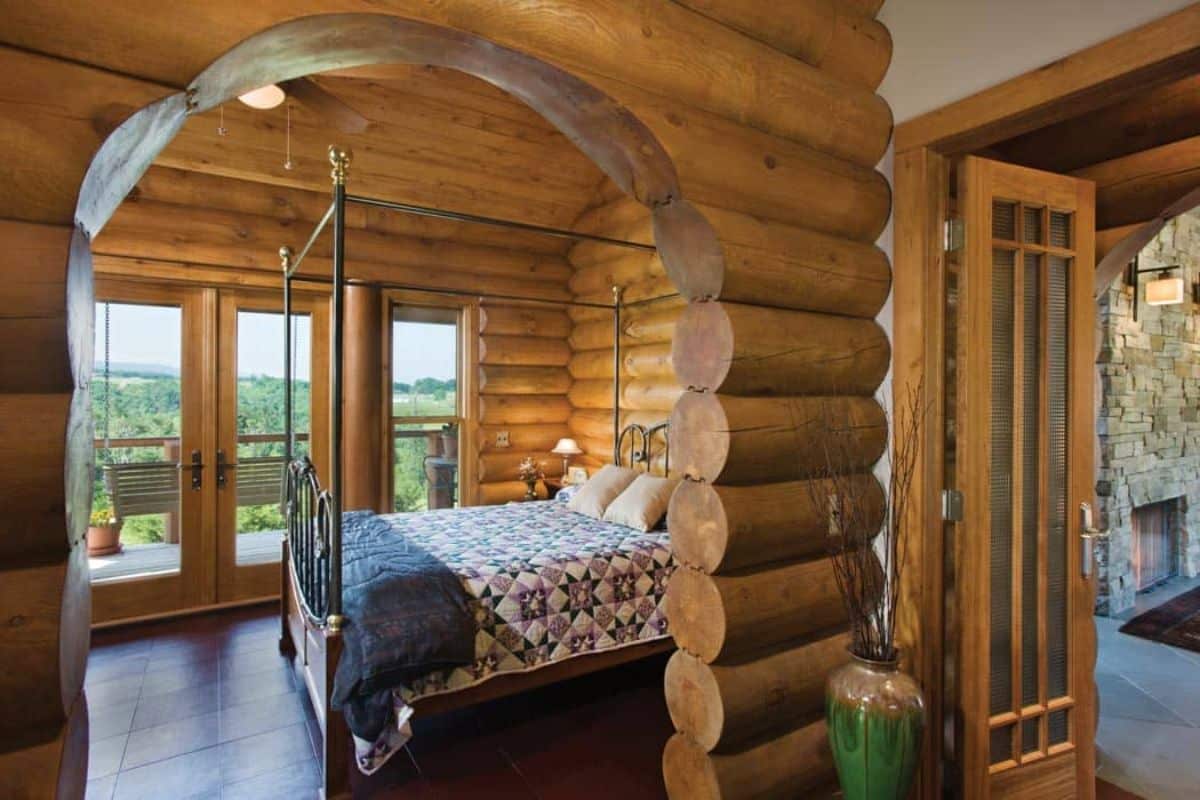 round log walls with arch looking into bedroom of log cabin