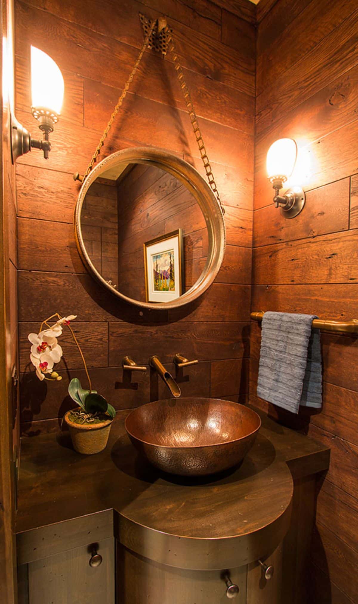 copper basin bathroom sink with round mirror hanging above