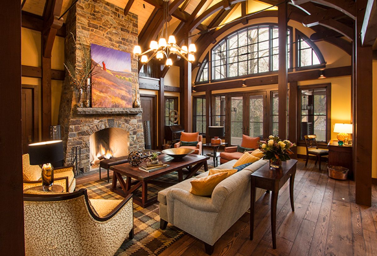 formal living area with white sofas and dark wood coffee table in front of fireplace