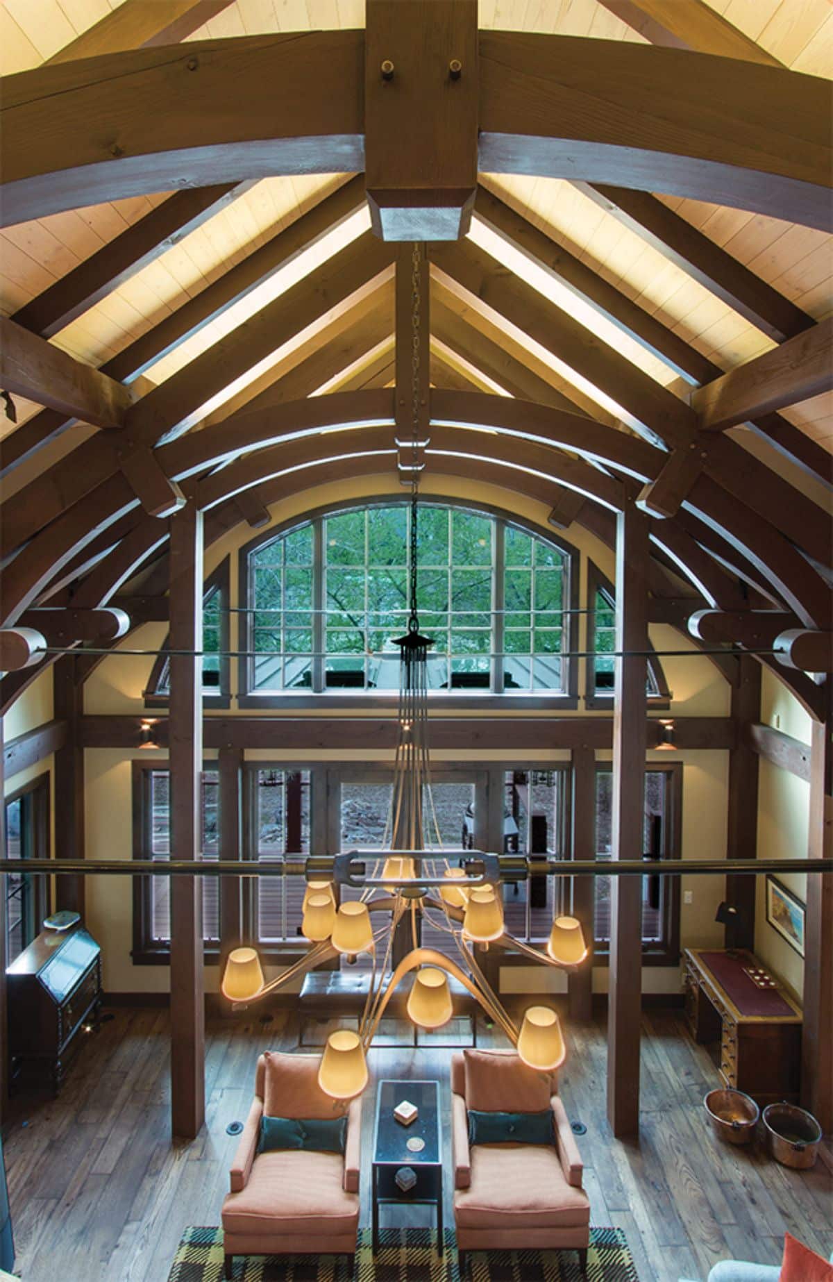 view across the top half of the home looking at exposed beams and out to the wall of windows