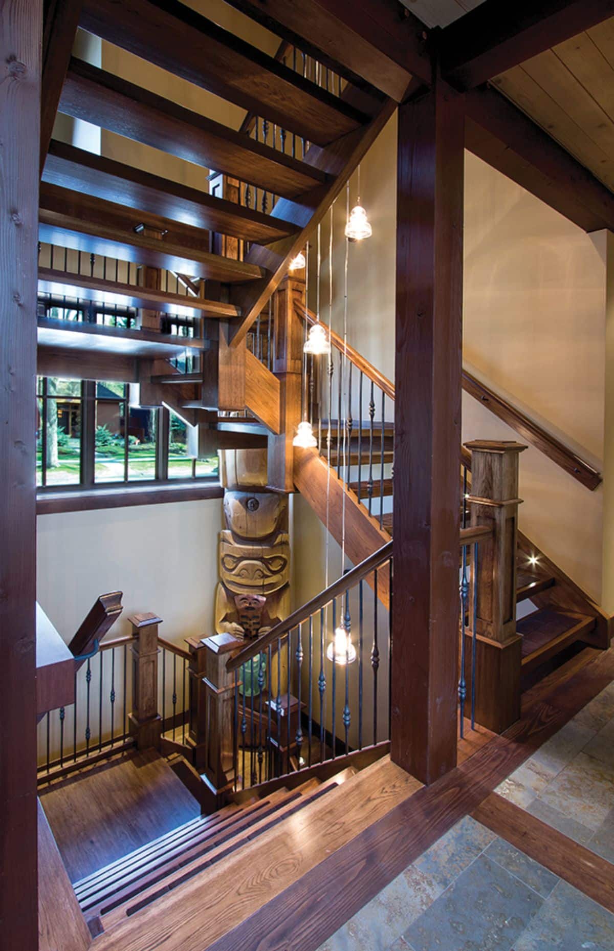 stairs going up to top floor with small landing at top space looking out windows