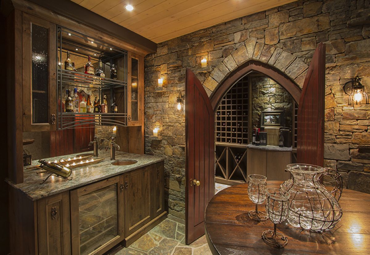 stone archway leading into wine cellar on right with bar on left